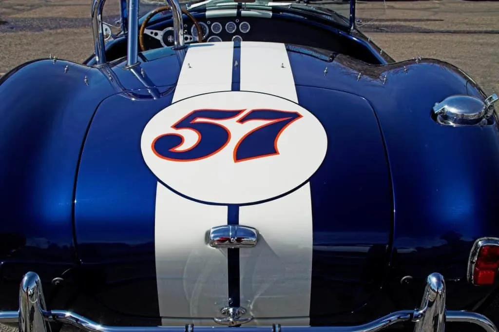 White racing stripe vinyl graphics on a blue classic roadster